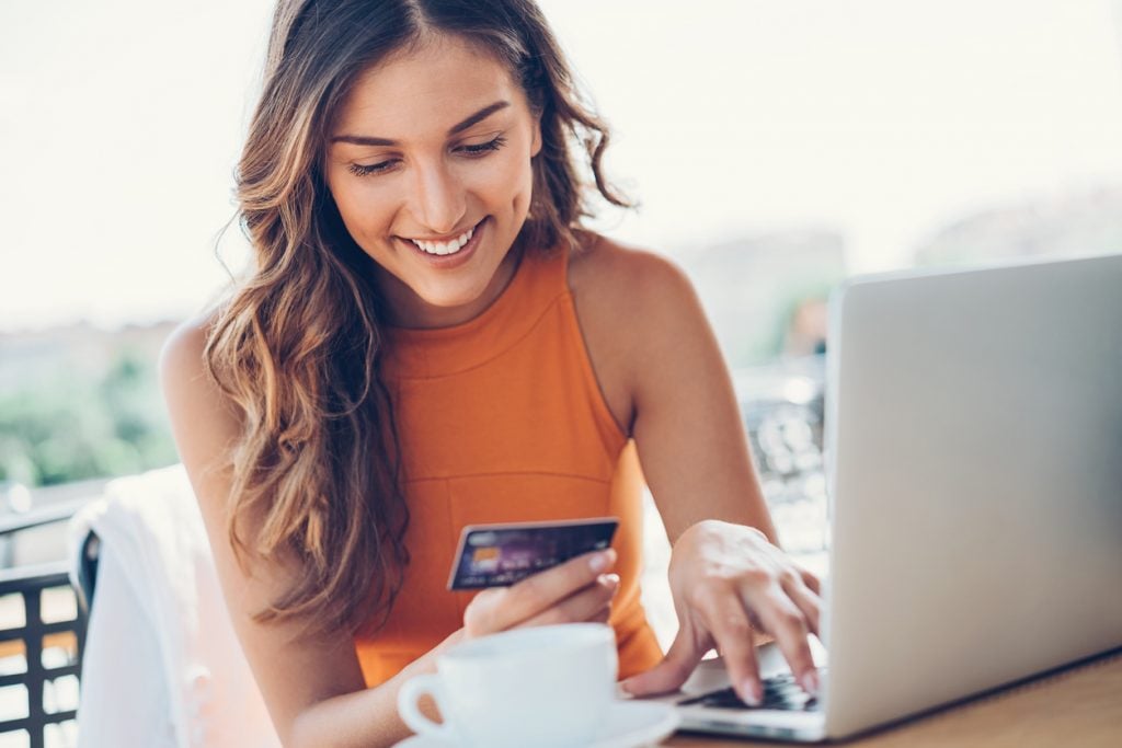 woman looking at credit card for video shopping